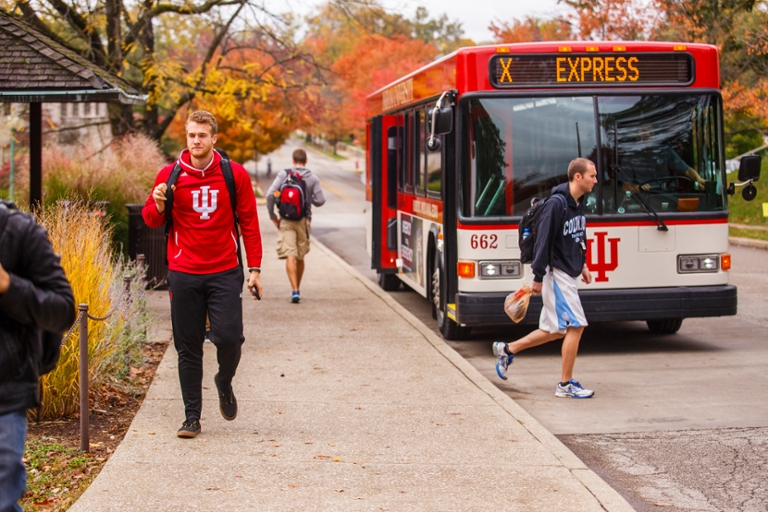 A group of IU Bloomington students getting off of the campus bus. 